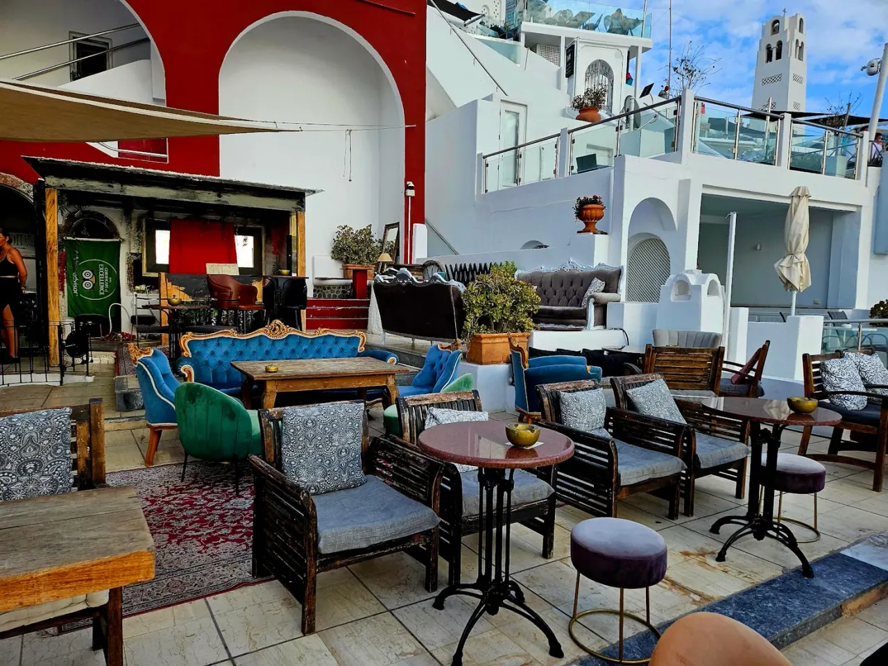 Mismatched vintage sofas and armchairs on the terrace of PK Cocktail Bar, Fira