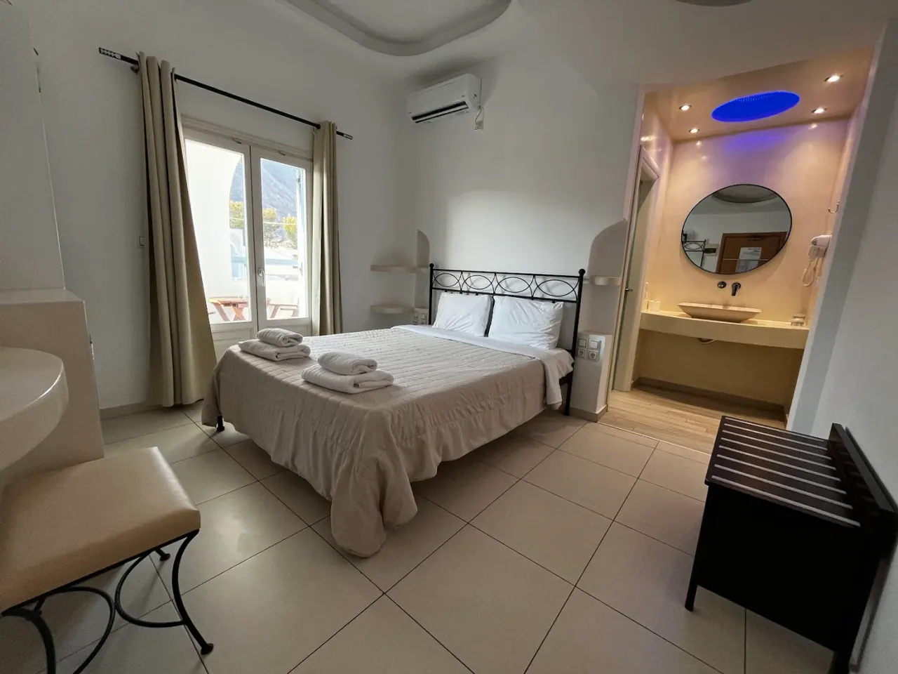 A bright, simple twin room with a balcony at Stelios Place in Perissa, Santorini