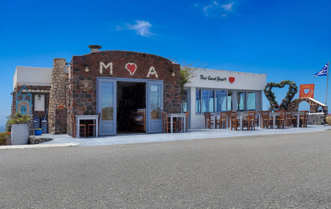 The stone facade and heart sign of The Good Heart taverna and deli in Akrotiri, Santorini