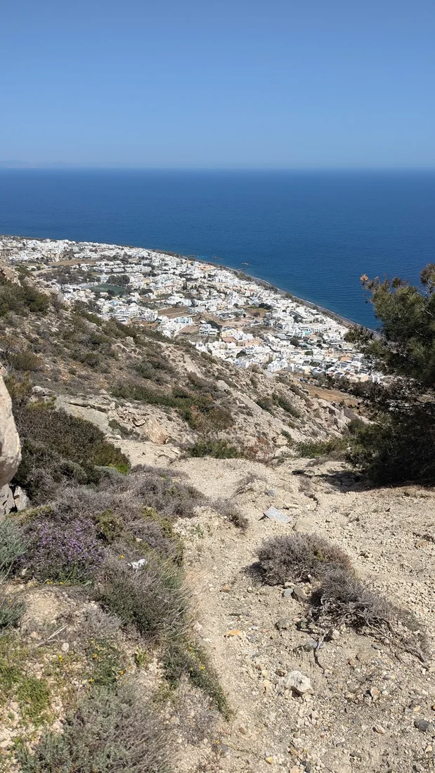 Perissa's long black volcanic-sand beach below the Mesa Vouno rock on Santorini