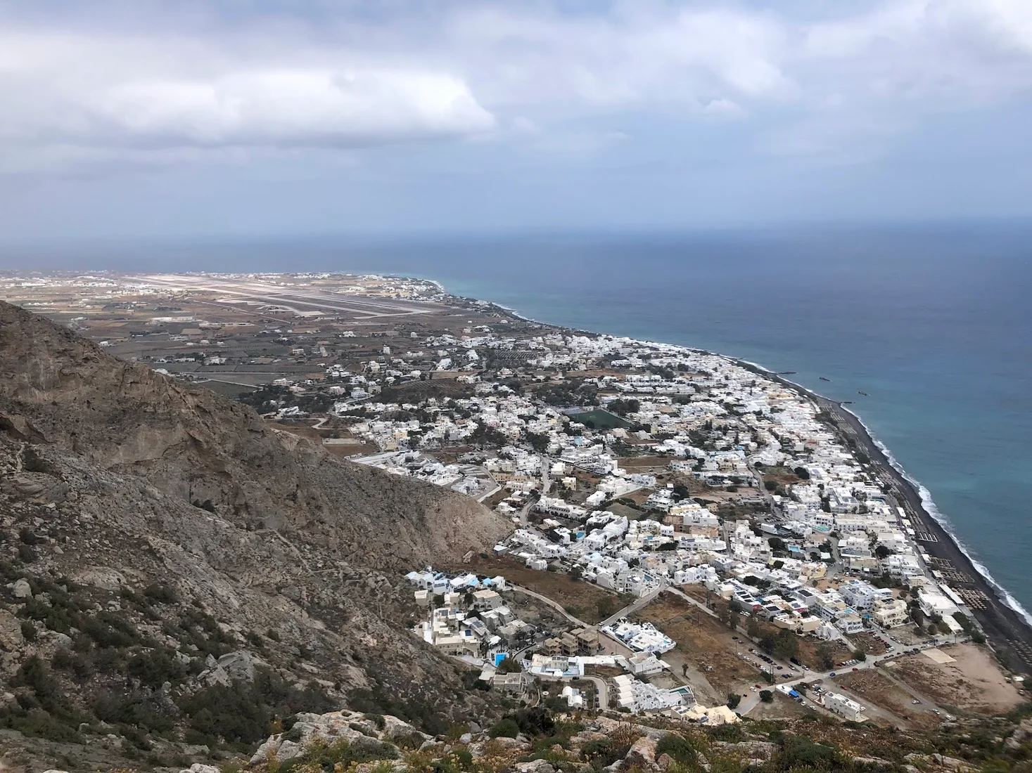 The view over Perissa and its black-sand beach from the Mesa Vouno hiking trail, Santorini