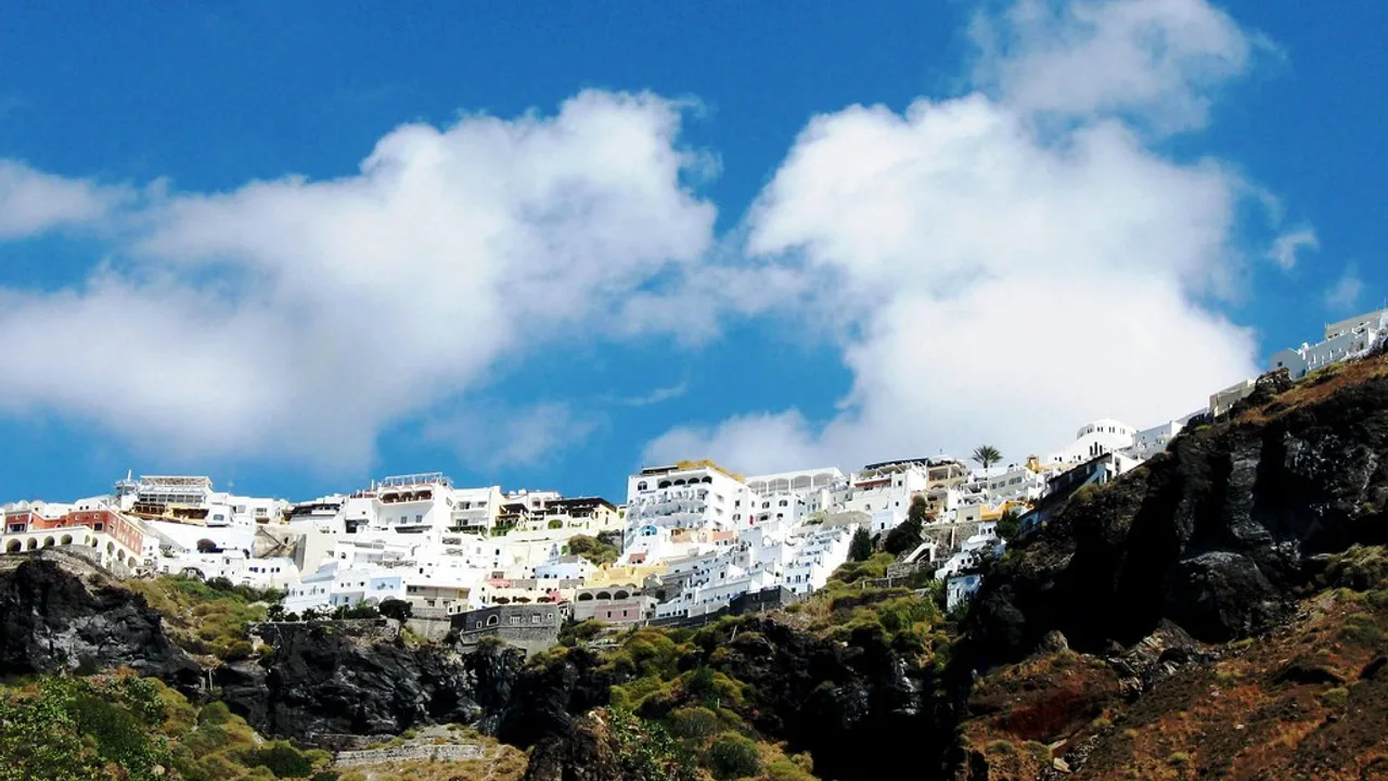The white clifftop town of Fira above the Santorini caldera and its old cruise port